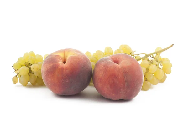 Two peaches and grapes branch on white — Stock Photo, Image