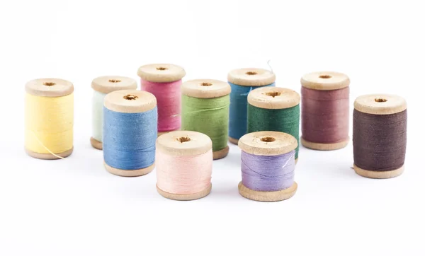 Wooden multicolored thread coils on white — Stock Photo, Image