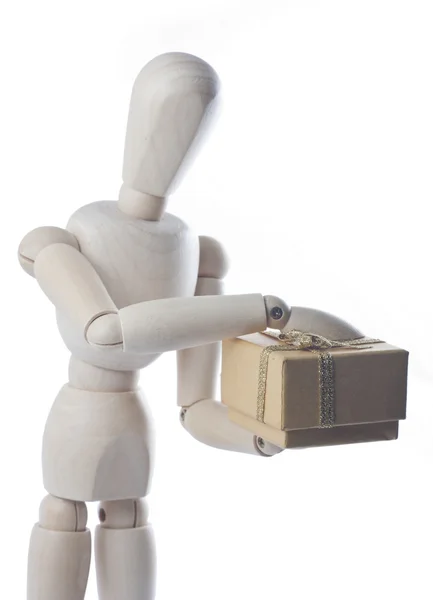 Wooden mannequin with gift — Stock Photo, Image