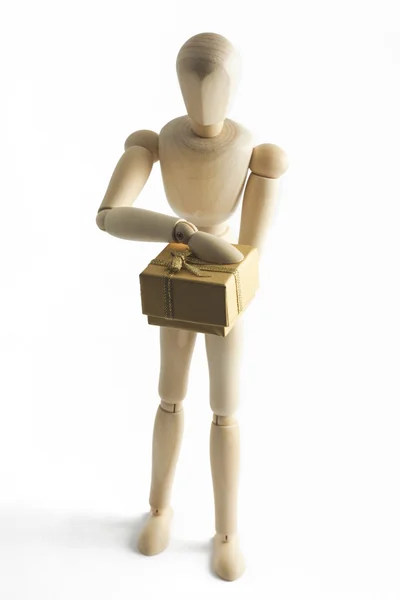 Wooden mannequin with a gift in hands — Stock Photo, Image
