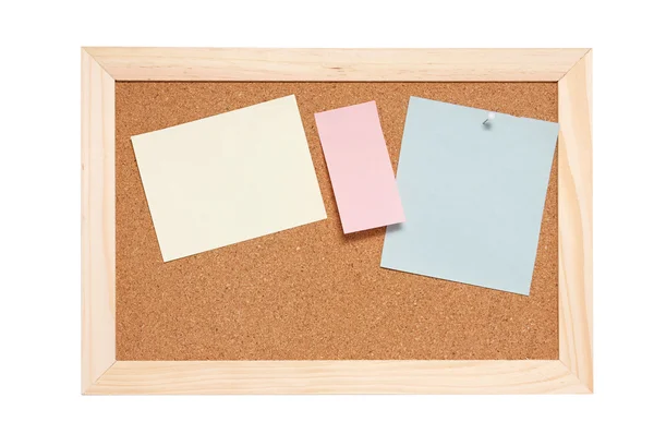 Corkboard with empty blue pink and yellow notes — Stock Photo, Image