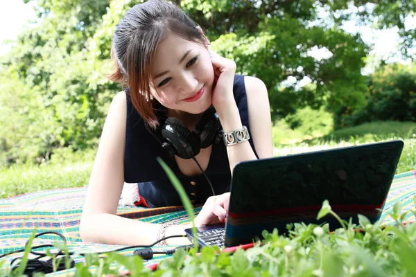 Young attractive girl is relaxing in the park — Stock Photo, Image