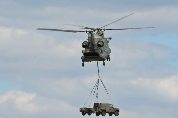 stock image Chinook Helicopter transporting Car