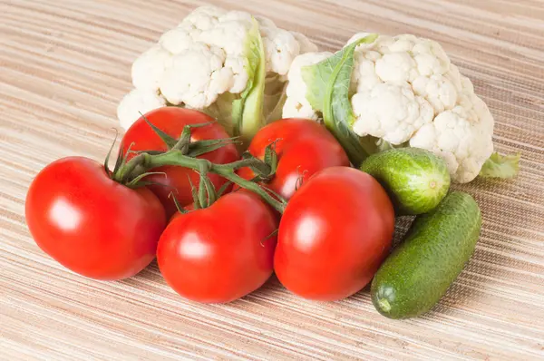 Vegetables, tomatoes, cucumbers, cauliflower on a table — Stock Photo, Image