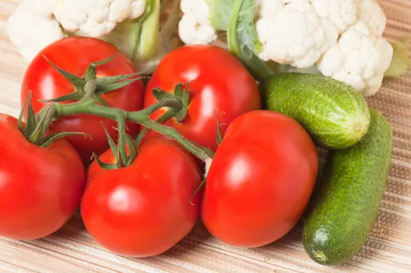 Vegetables, tomatoes, cucumbers, cauliflower on a table — Stock Photo, Image