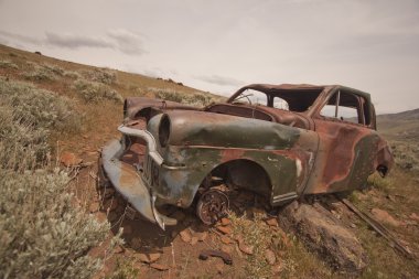 Old abandoned car with bullet holes clipart