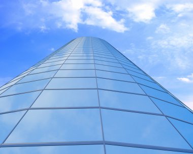 High-altitude glass buildings with the sky and clouds clipart
