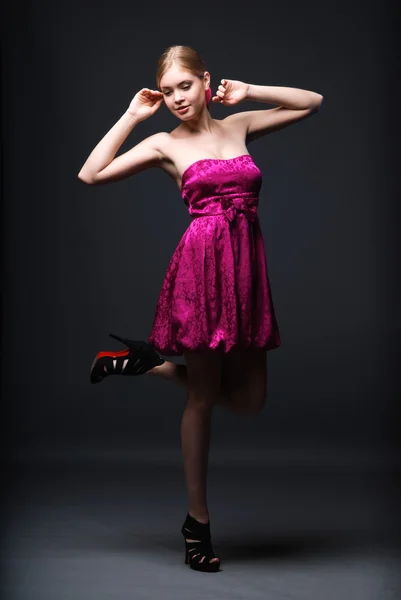 stock image Beautiful young woman wearing pink dress and high heels