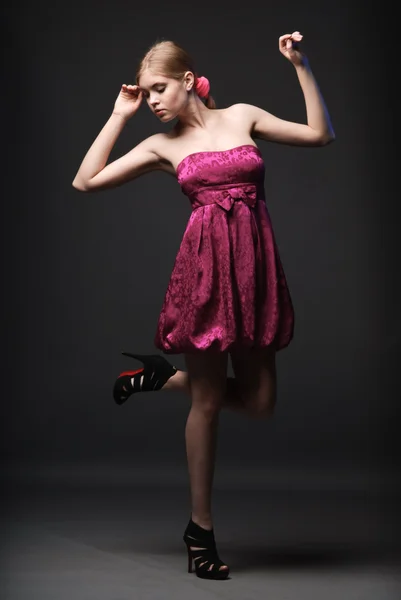 stock image Beautiful young woman wearing pink dress and high heels