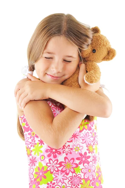 Little girl hugging bear toy
