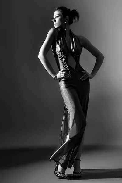 Modemodel in langer Kleidung auf dunklem Hintergrund — Stockfoto