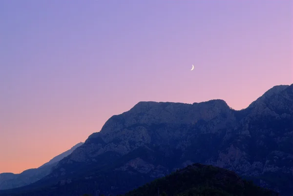 New moon over a mountains — Stock Photo, Image