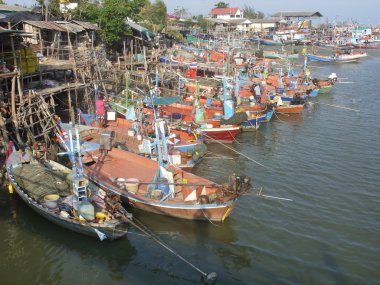 Moored fishing boats at Cha-am harbour, Thailand clipart