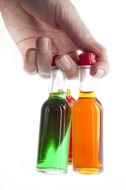 MiniBar bottles with alcohol in the hand clipart