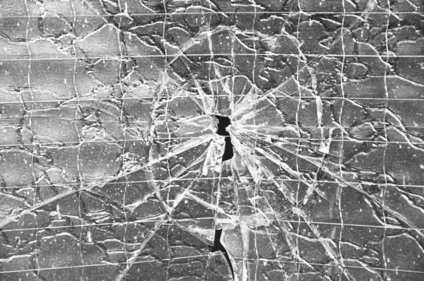 stock image Hole with cracks in the reinforced glass