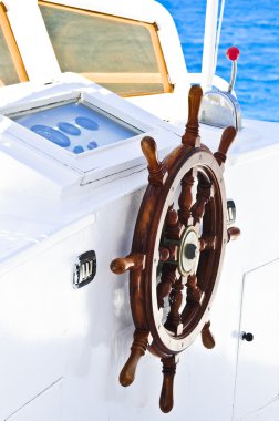 The wood steering wheel of a captain's bridge on the yacht clipart