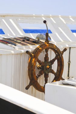 The wood steering wheel of a captain's bridge on the yacht clipart