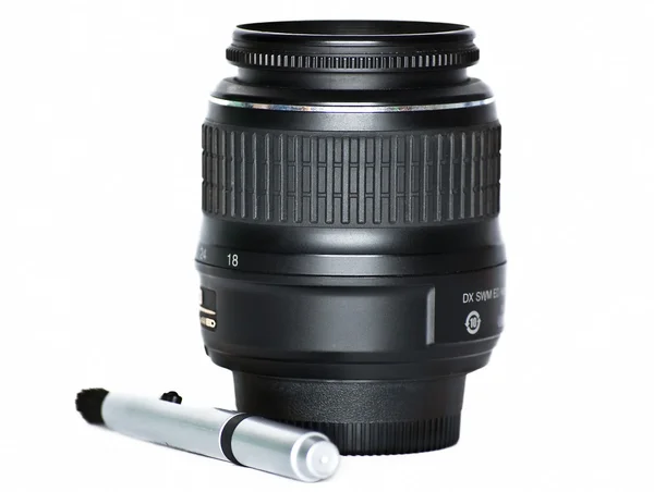 Lens for a mirror camera and a special pencil for cleaning optics on a whit — Stock Photo, Image
