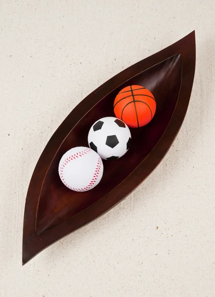 Three kind of balls in the wooden leaf tray — Stock Photo, Image