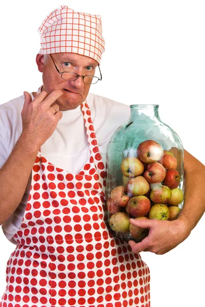 Un homme avec un énorme pot rempli de pommes — Photo
