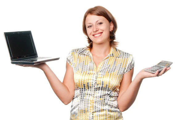 Smiling girl chooses between the laptop and the calculator — Stock Photo, Image