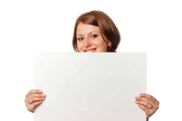 Smiling girl looks out from blank sheet — Stock Photo, Image