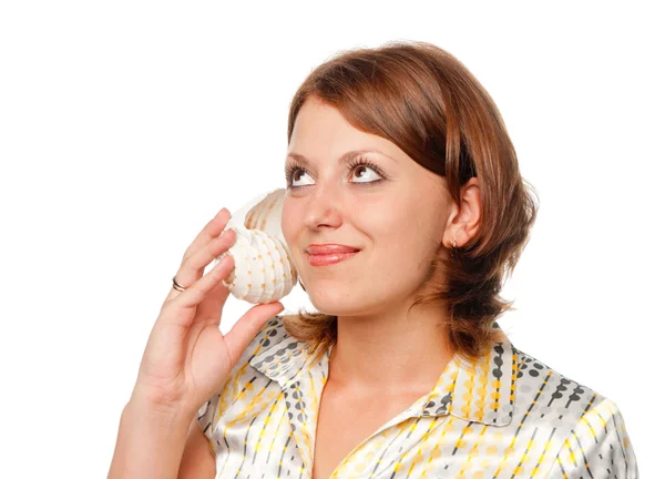 Girl listens to a seashell — Stock Photo, Image