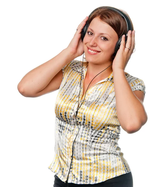 stock image Smiling girl listens to music in ear-phones