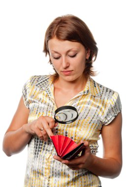 Girl considers a purse through a magnifier clipart