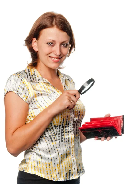 Smiling girl considers a purse through a magnifier — Stock Photo, Image