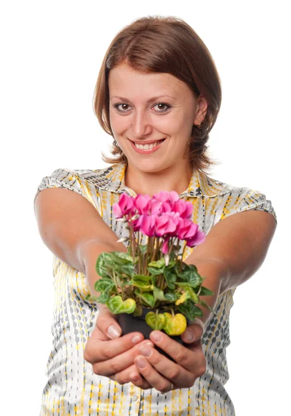 Smiling girl with cyclamens — Stock Photo, Image