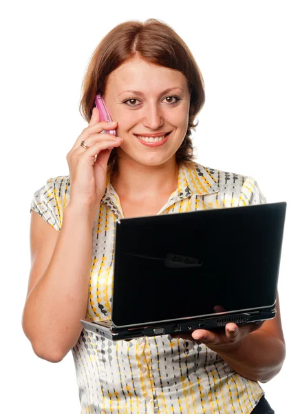 Дівчина з ноутбуком говорить по мобільному телефону — стокове фото