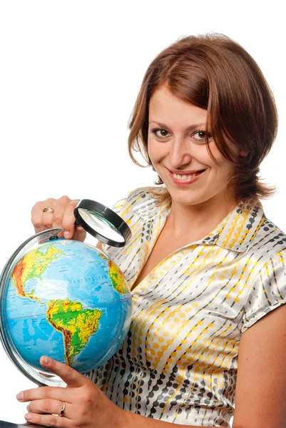 stock image Smiling girl examines the globe through a magnifier