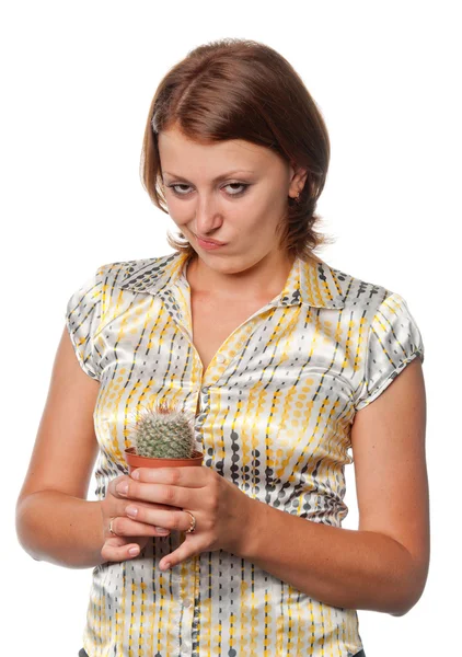 Dissatisfied girl with a cactus — Stock Photo, Image