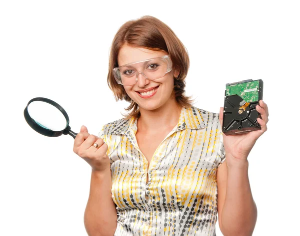Smiling girl with hard driver and magnifier — Stock Photo, Image
