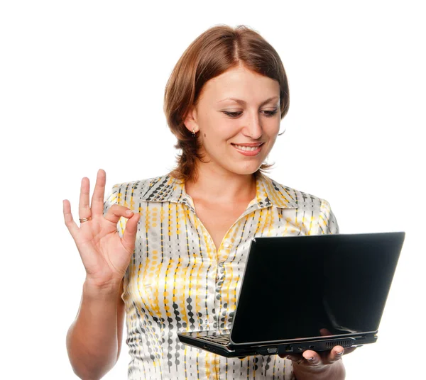 Smiling girl with laptop shows gesture "OK" — Stock Photo, Image