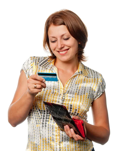 Mädchen schaut auf Kreditkarte Stockbild