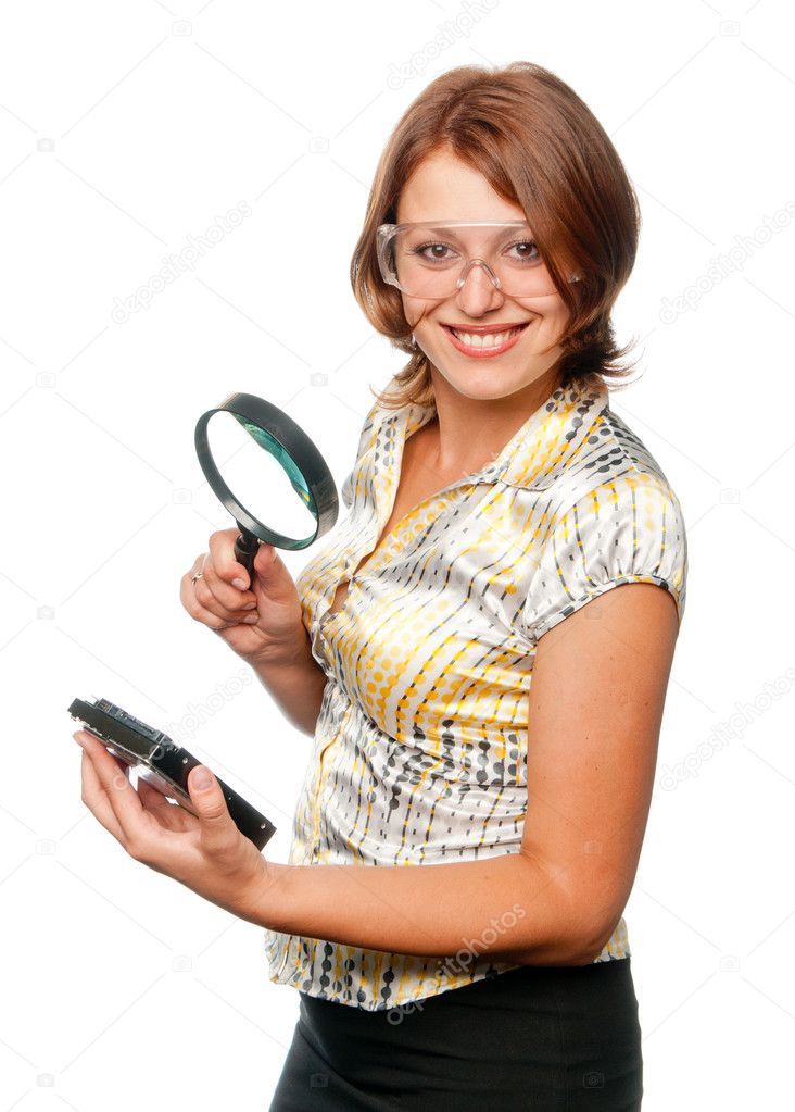 Smiling girl considers hard driver through a magnifier