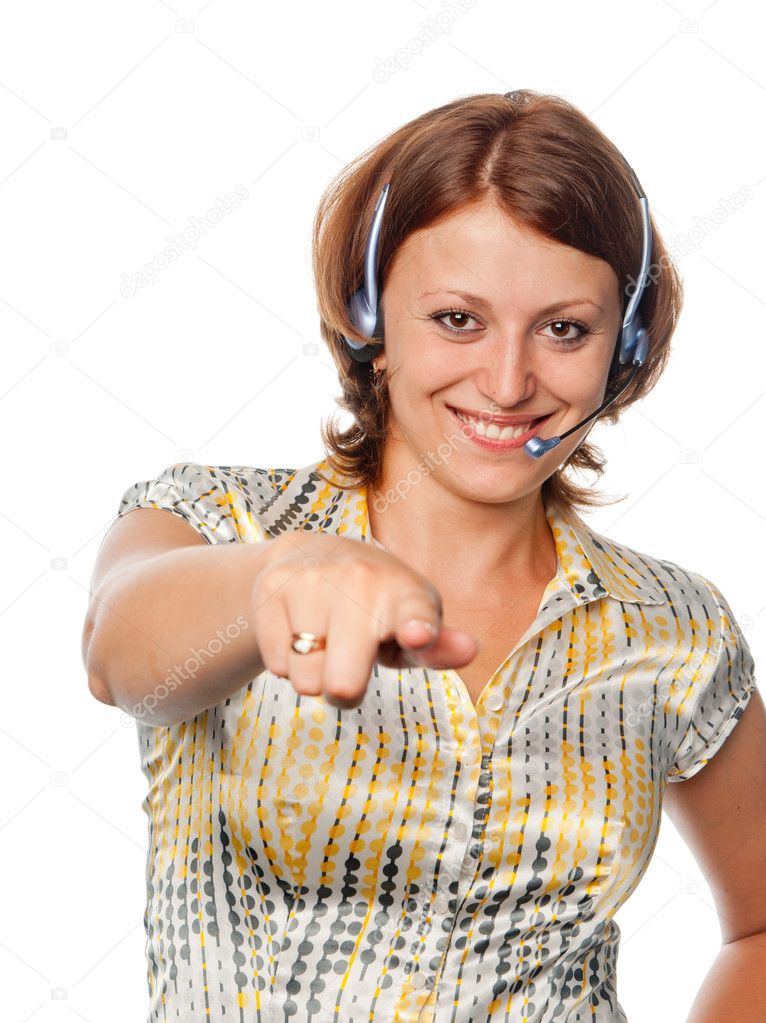 Smiling girl with ear-phones and a microphone points a finger