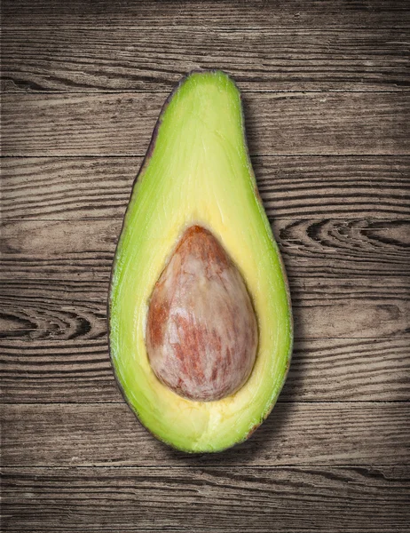 Avocado on wooden table.