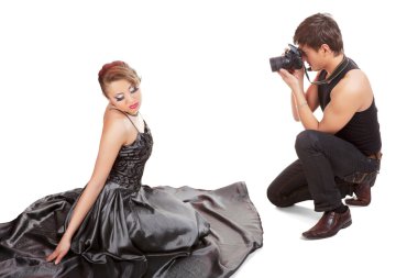 Young adult female Caucasian model being photographed in studio clipart