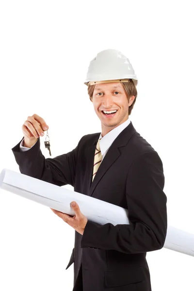 Smiling engineer giving keys from apartment — Stock Photo, Image