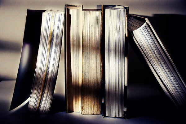 Heap of old books against white background