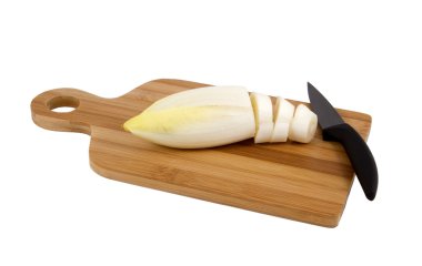 Chicory and ceramic knife on a board. clipart