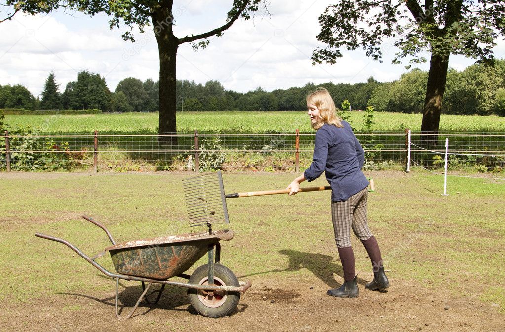 Girl cleaning the manure