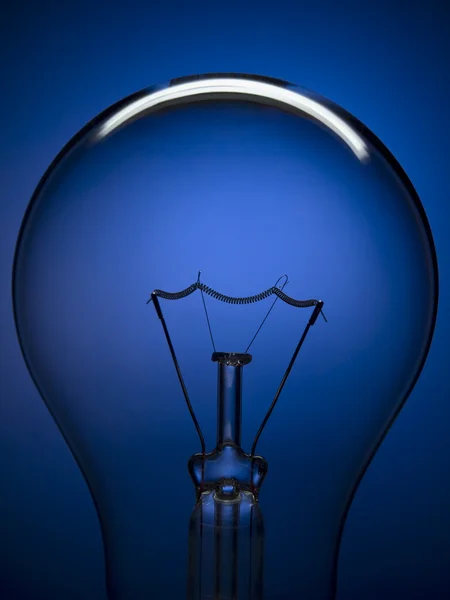 Bulb light on blue — Stock Photo, Image