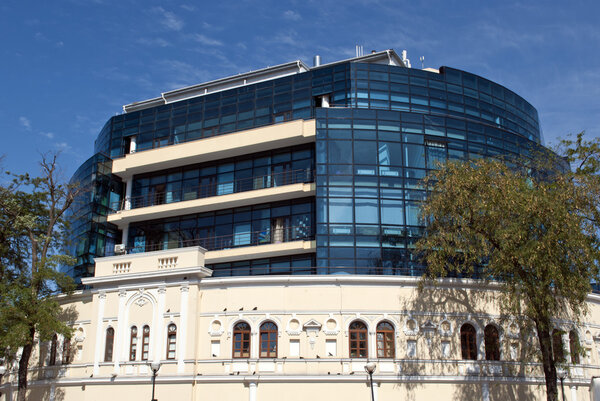 A modern building with blue windows, the facade