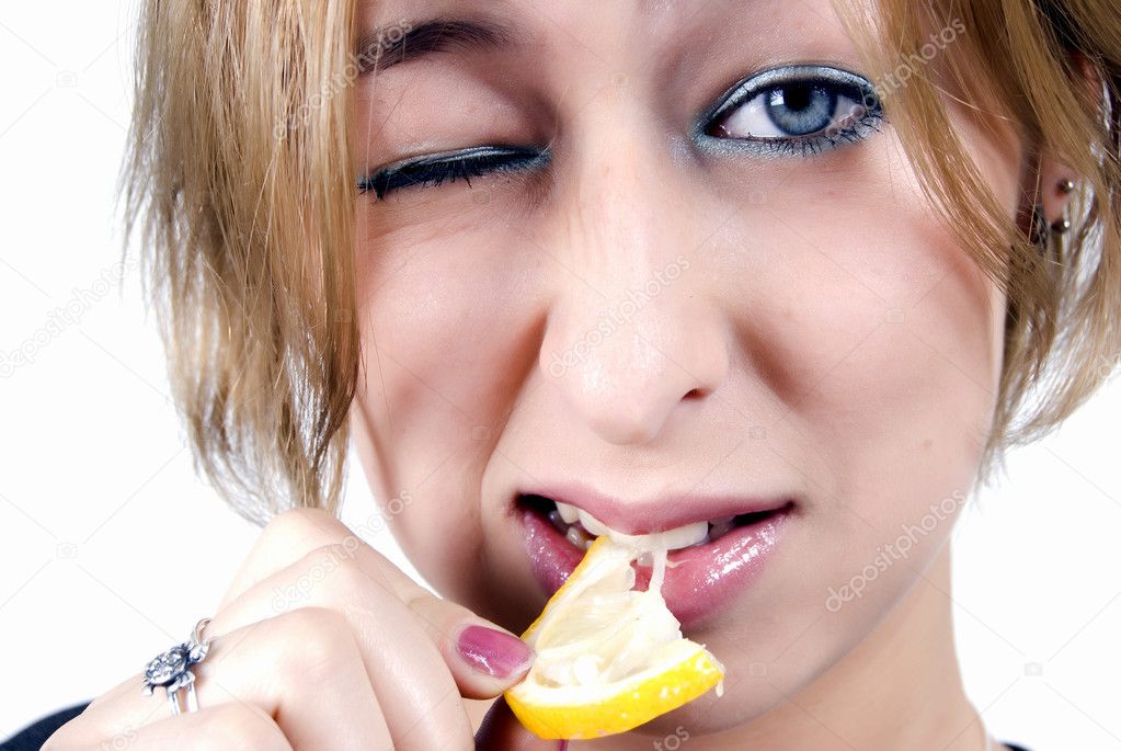 Girl eating a lemon