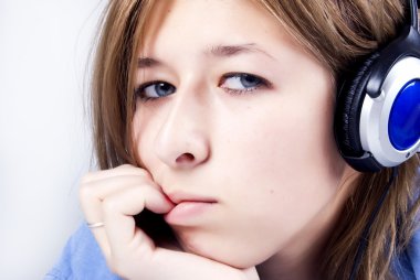 Young sad girl listening to music clipart