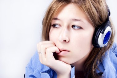 Young girl listening to music being clipart